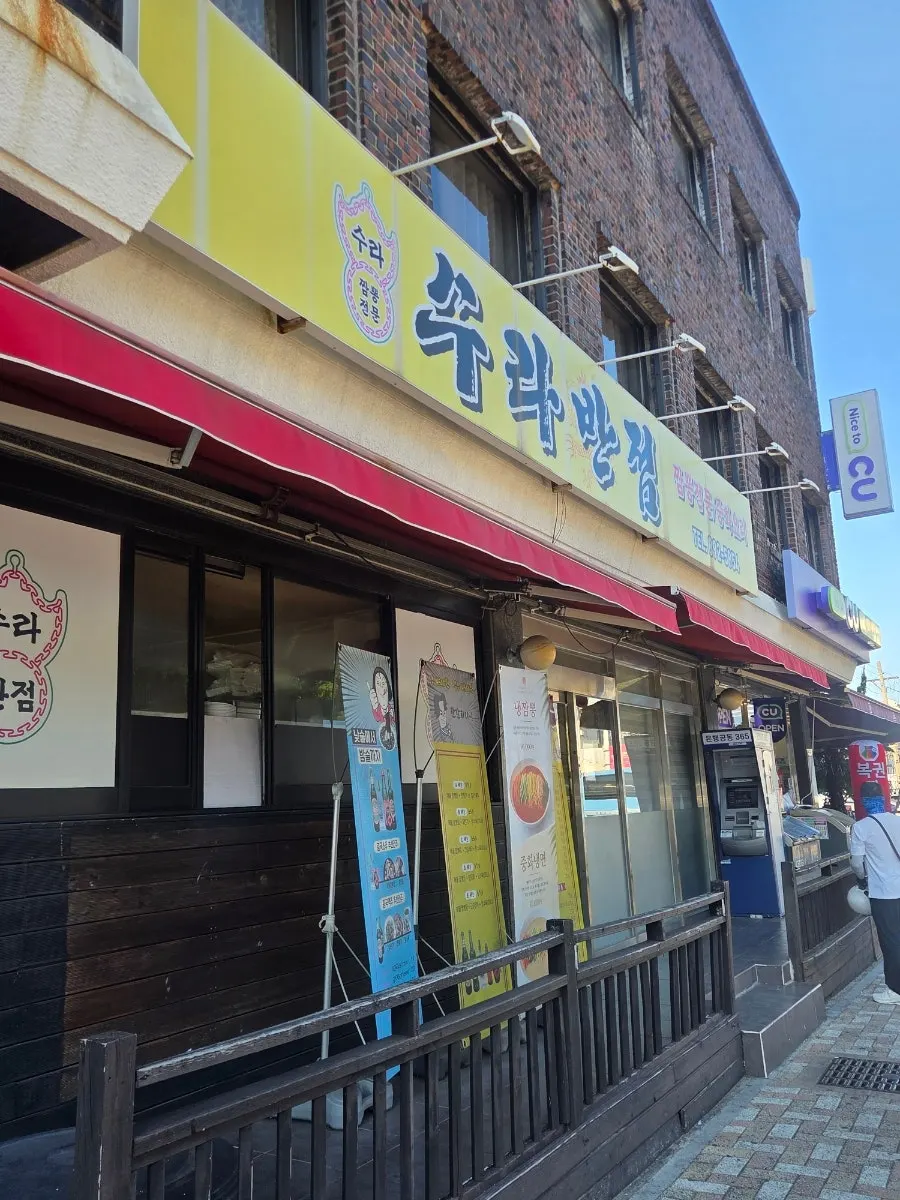 수라반점 가야점 주변 버스와 뒤편 산이 보이는 거리 풍경