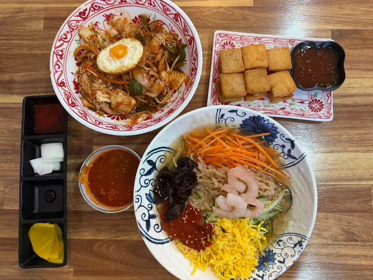 Full spread of Chinese bibimbap, seafood cold jjamppong, and mangboksa
