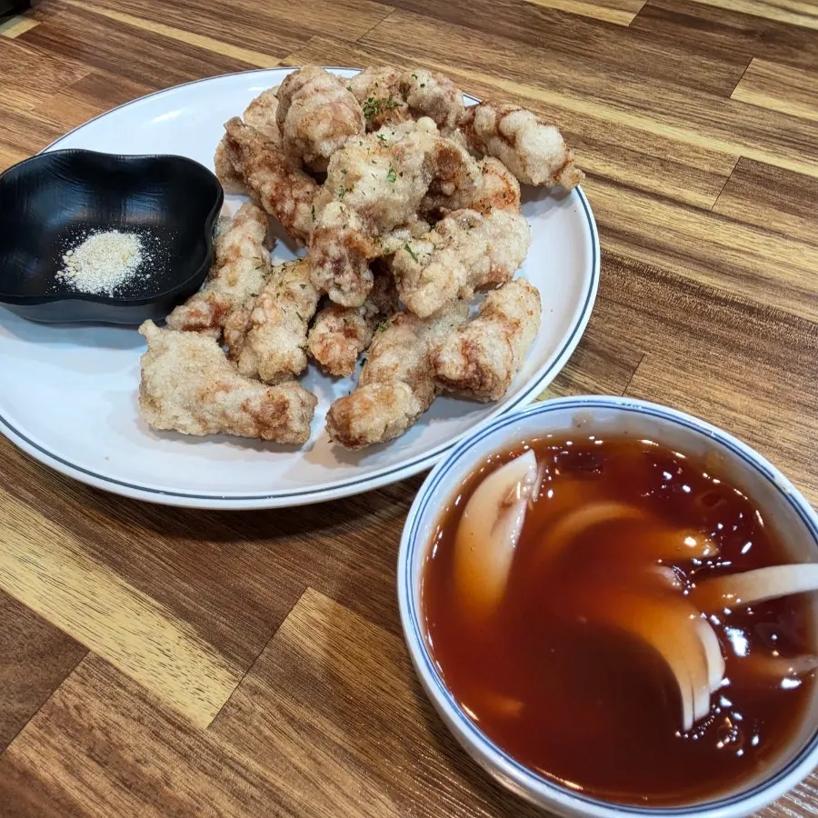 A piece of sweet rice tangsuyuk dipped in sauce