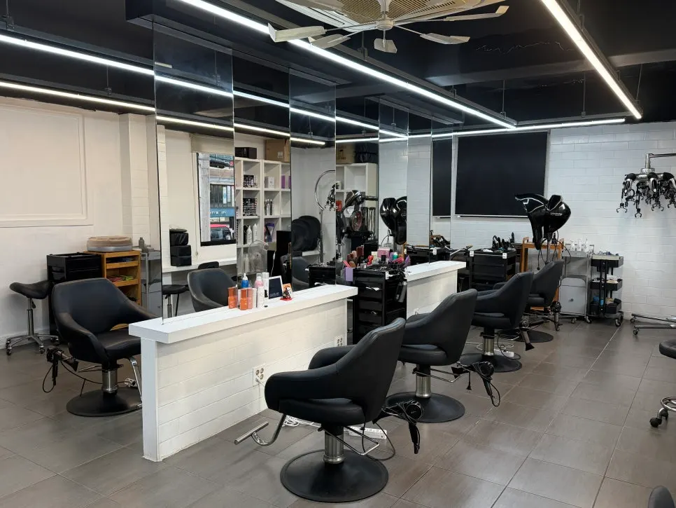 Salon interior with white tile and black wood tones