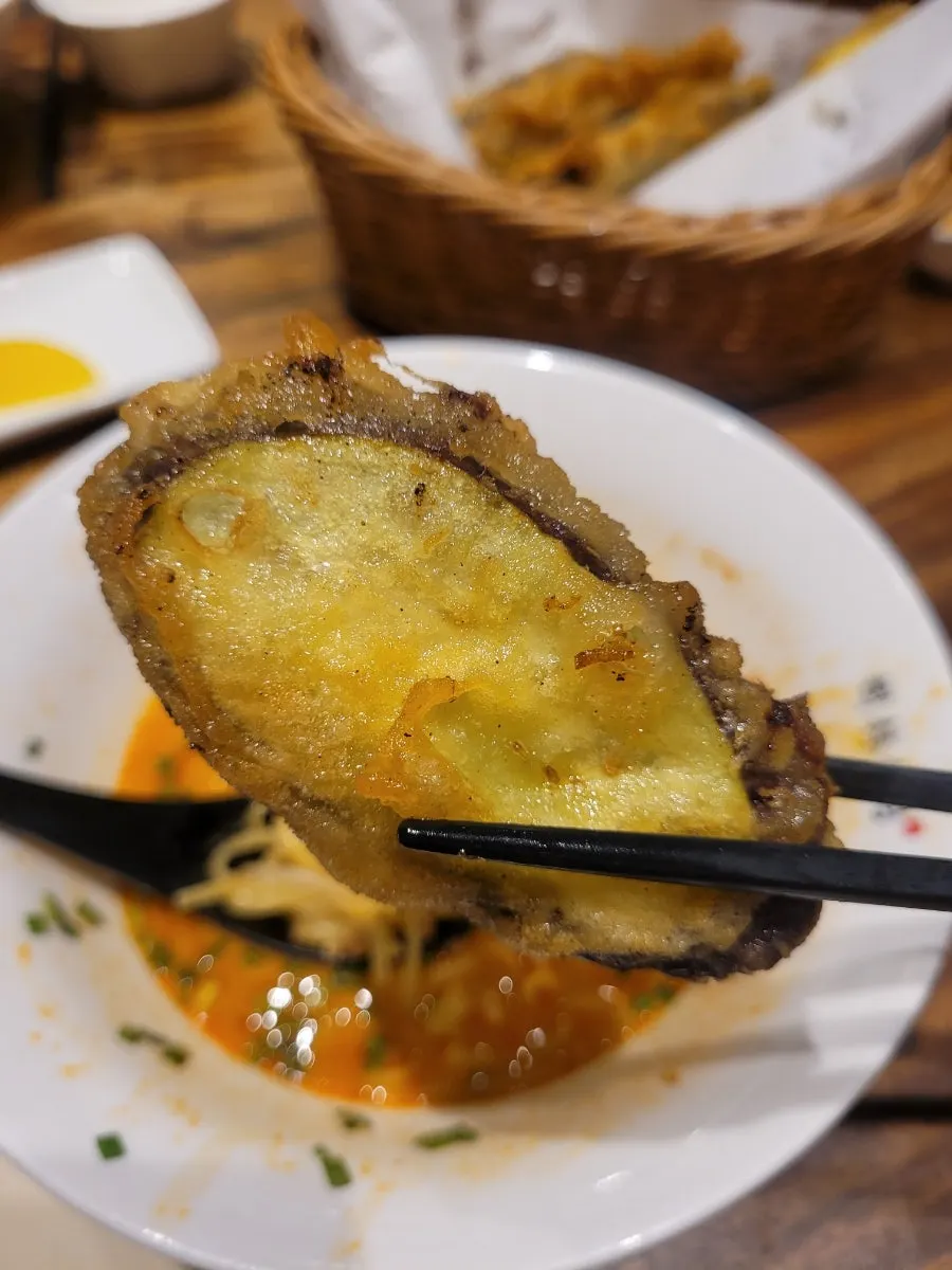 Eggplant mandu dipped in fried soy sauce and mala sauce