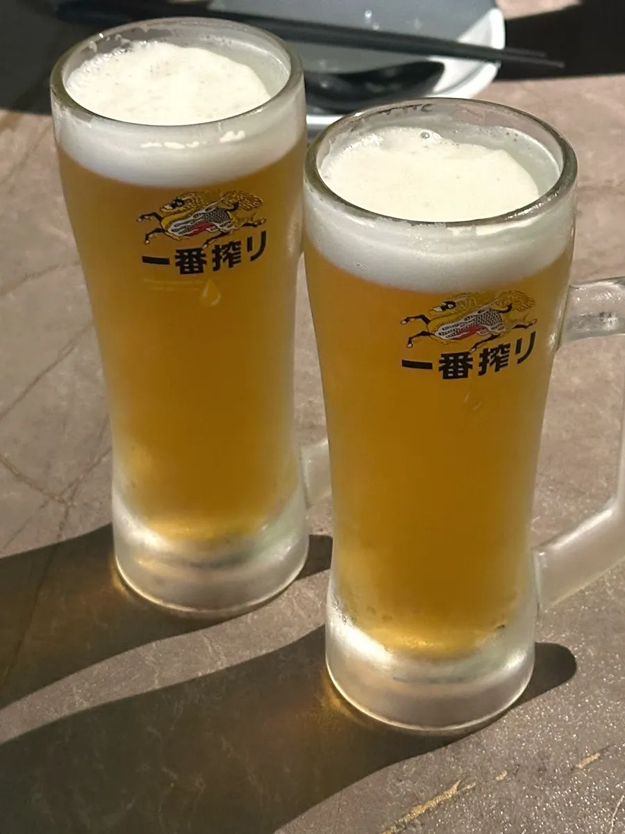 A glass of foamy Kirin draft beer