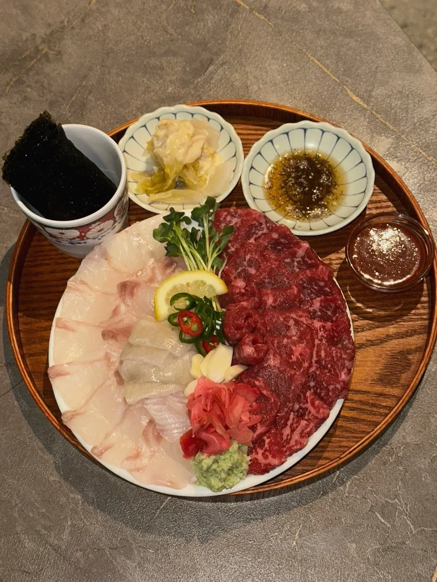 Picking up a piece of yuksashimi with chopsticks