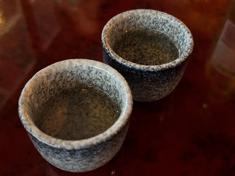 A glass of welcome sake served per person