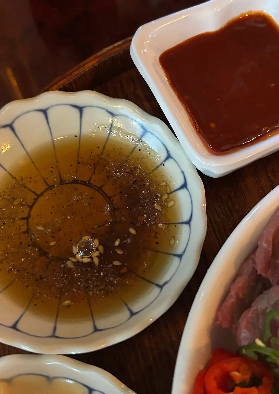 Side dishes including baek-kimchi and sesame oil sauce