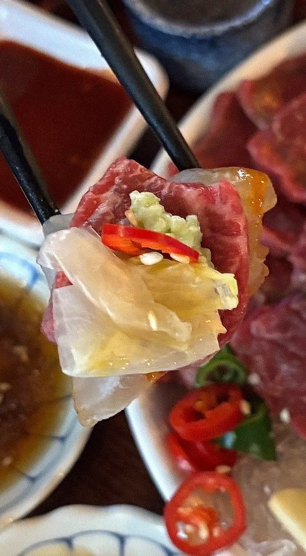 Aged sashimi and baek-kimchi wrapped in gim