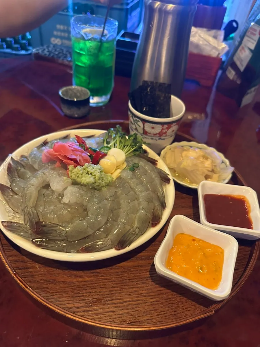 Freshly served plate of raw shrimp sashimi