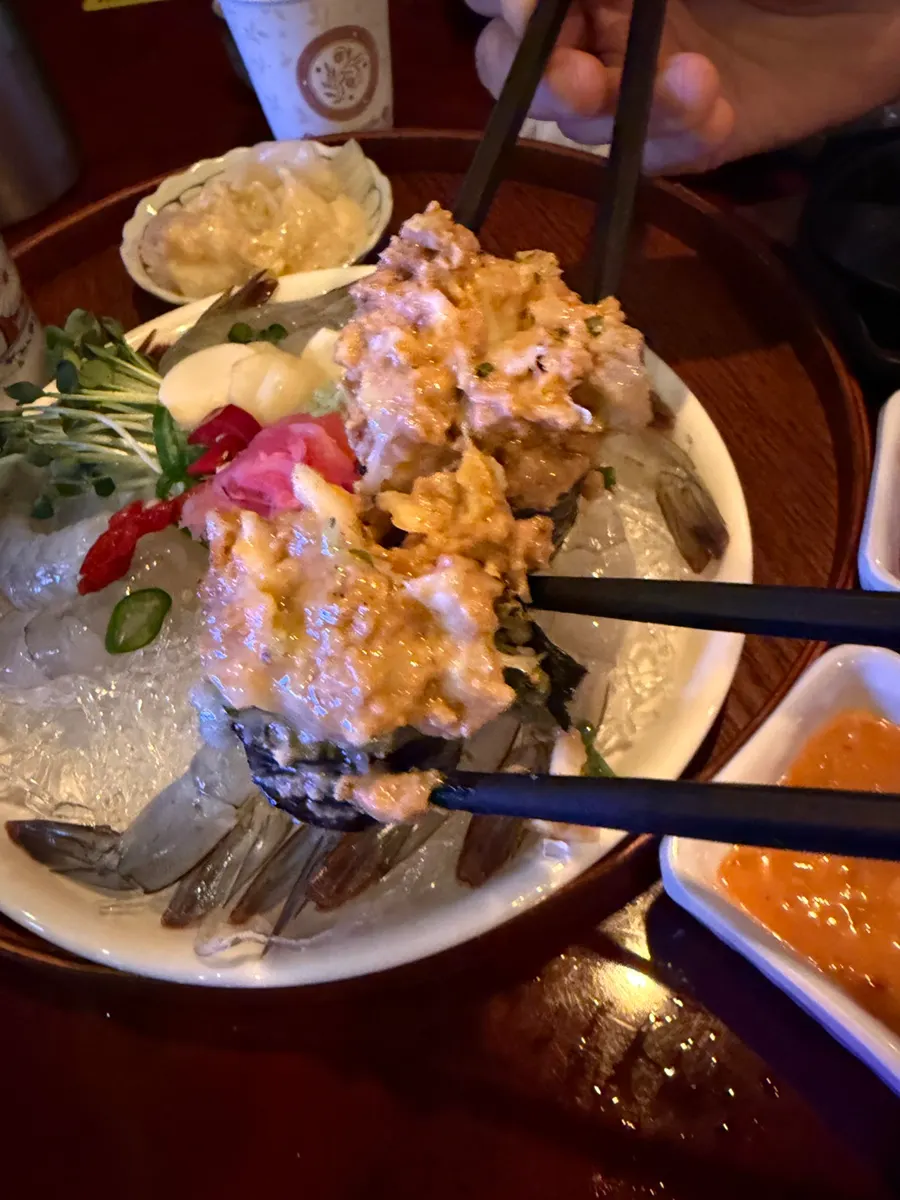 Ankimo placed on top of raw shrimp