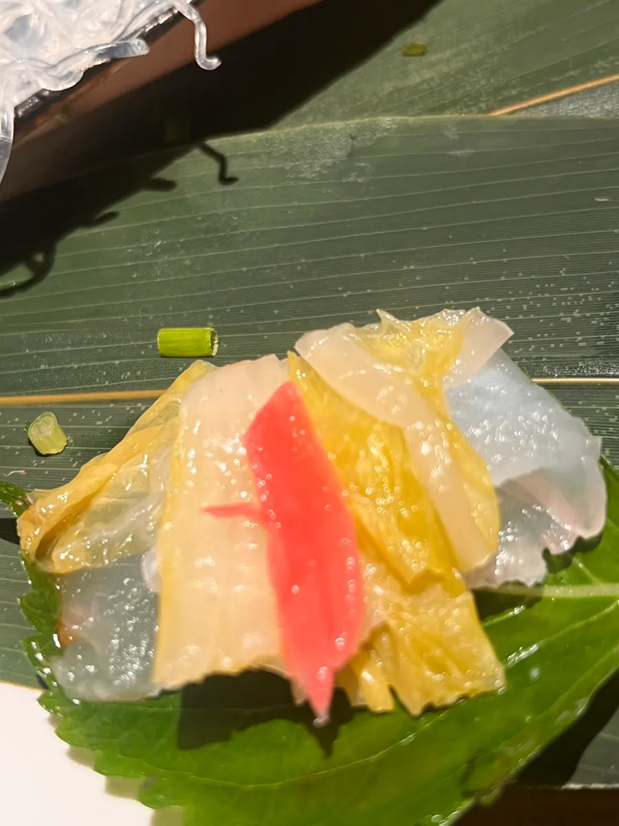 A bite combining sashimi and seafood together