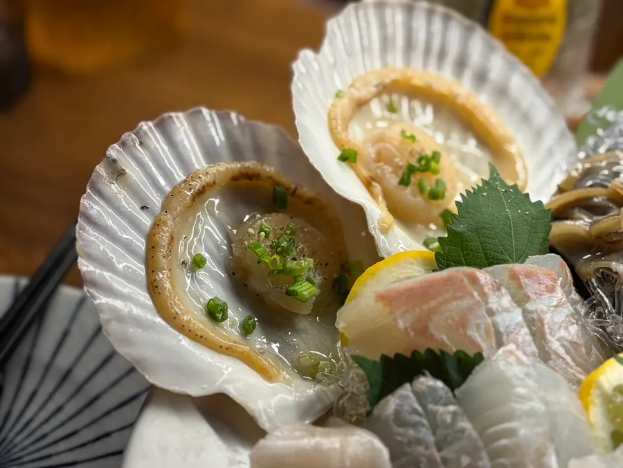 Scallop sashimi, abalone, and sea cucumber arrangement