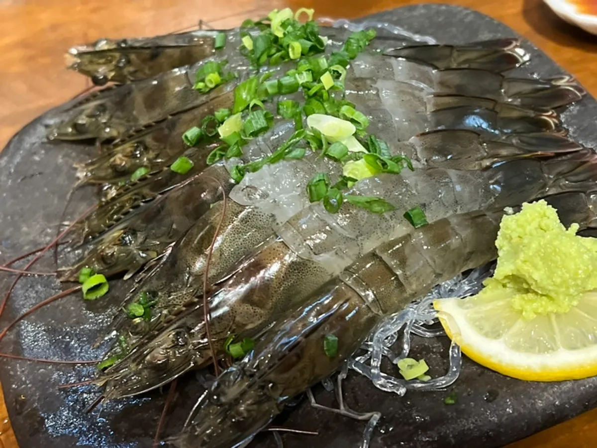 A plate of raw shrimp sashimi prepped to order