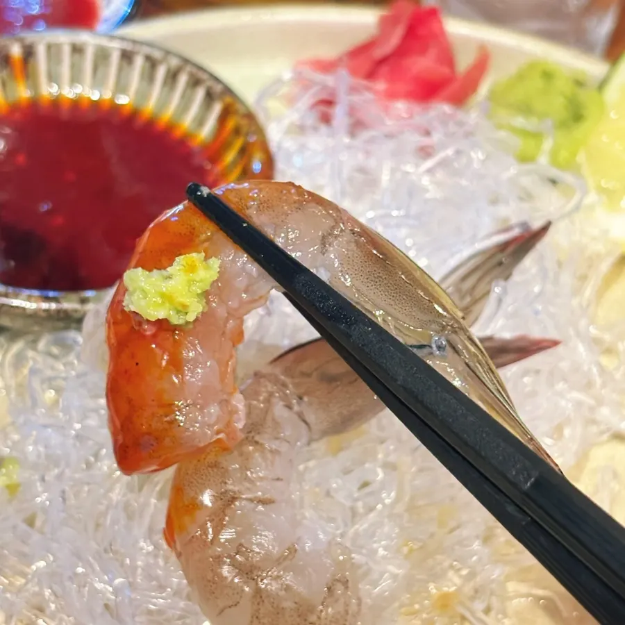 Raw shrimp sashimi dipped in buldak sauce