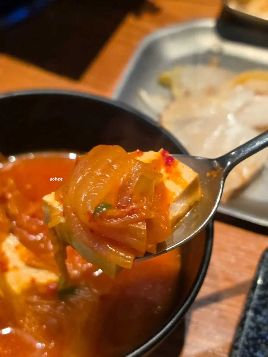 A full spread of thick samgyeopsal and kimchi jjigae