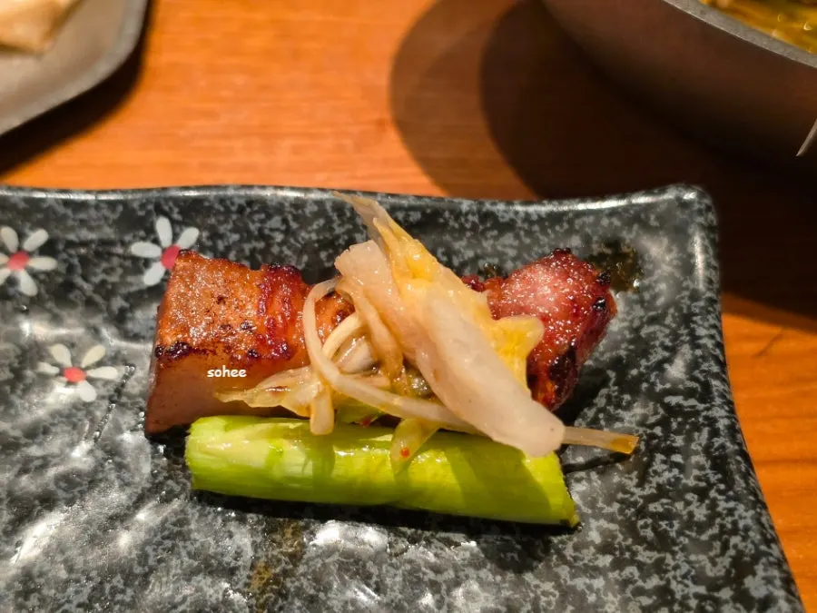 Samgyeopsal served with grilled white kimchi and shredded scallion salad