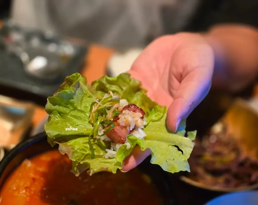 A piece of samgyeopsal plated together with asparagus