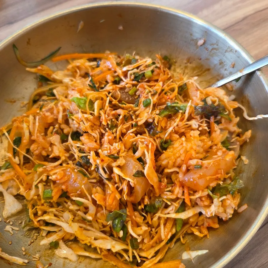 Chojang sauce being poured into the sashimi bibimbap