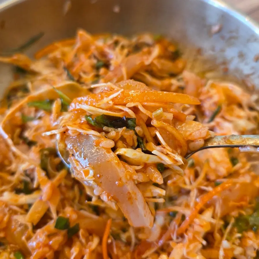 Bright red sashimi bibimbap mixed with chojang sauce