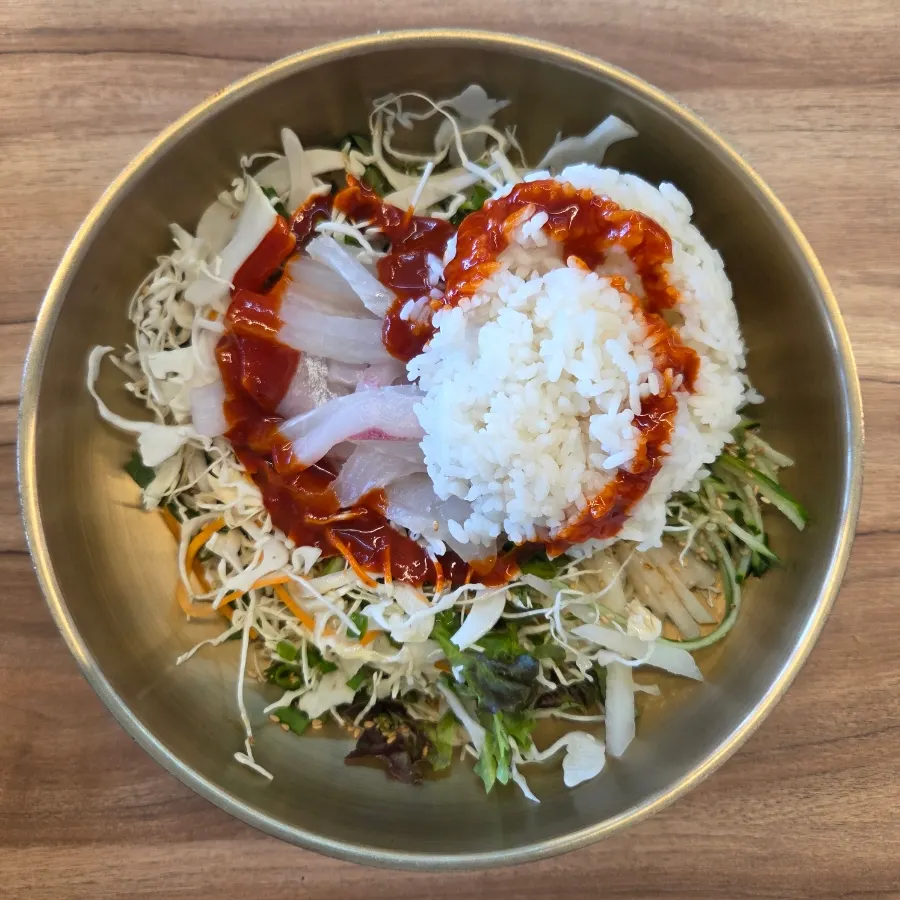 A big spoonful of sashimi bibimbap lifted from the bowl