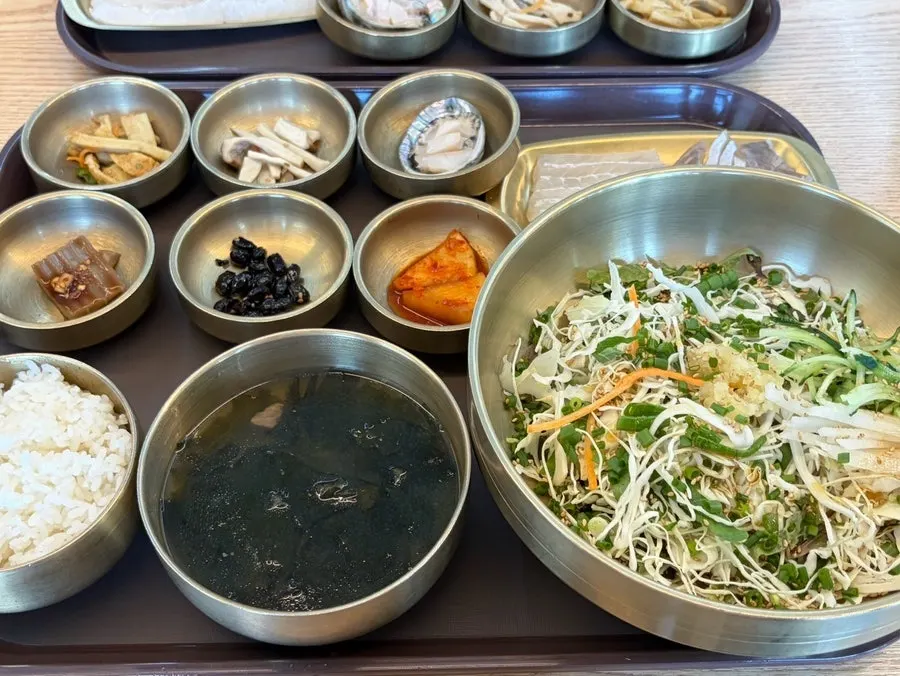 Table spread with half-and-half sashimi bibimbap and flounder mulhoe