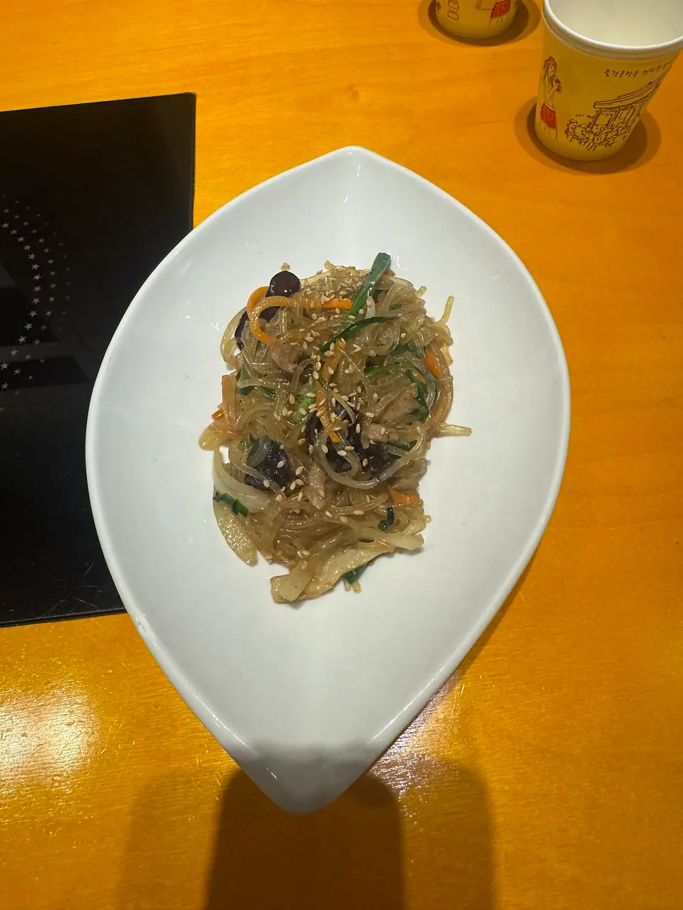 Menu listing spicy pork stir-fry and cockle salad
