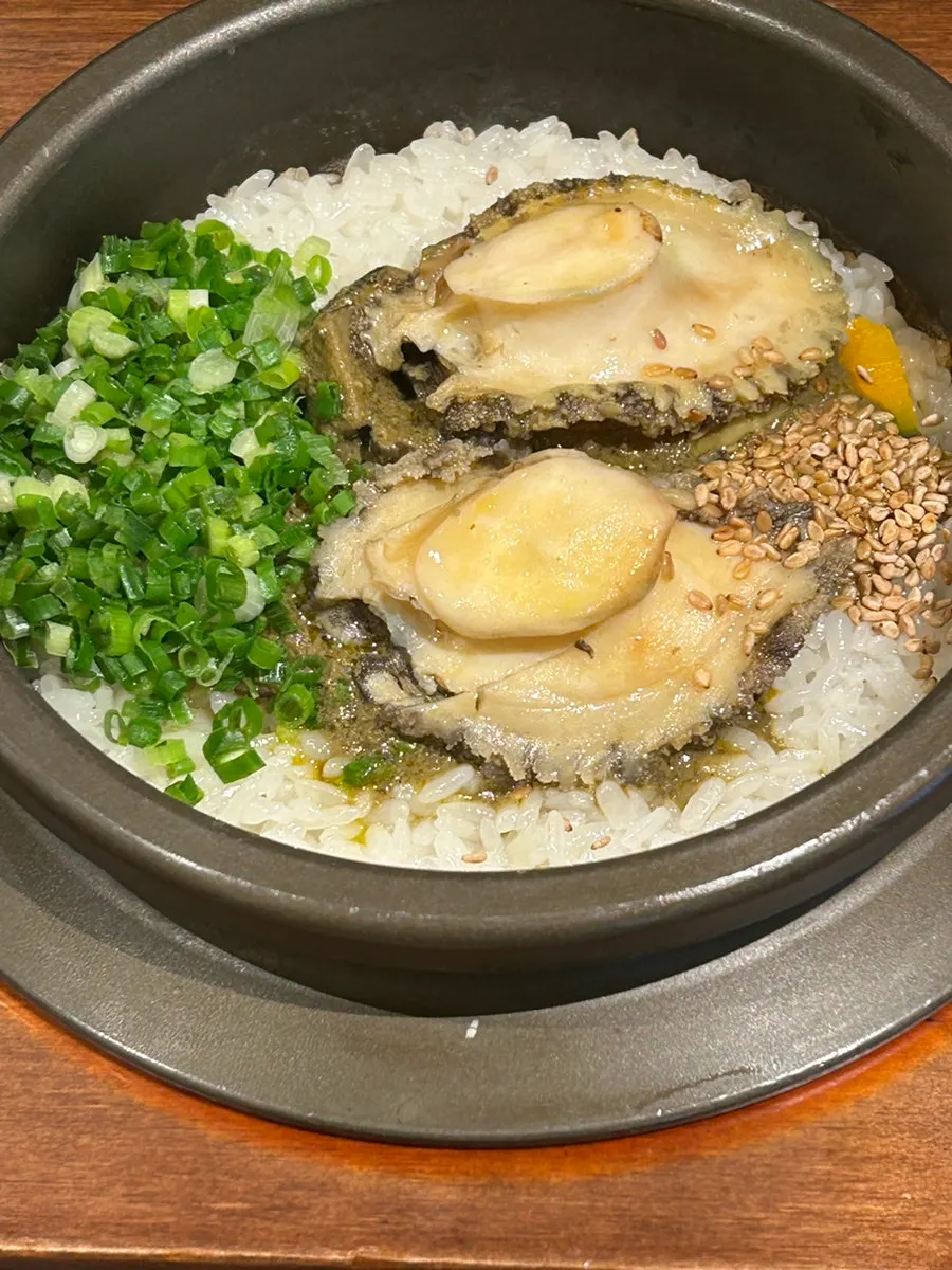 Two whole abalones on top of the Wando abalone sotbap