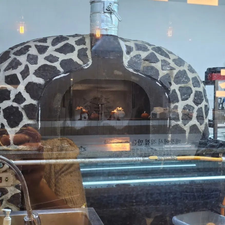 Wood-fired mackerel oven opposite the self-bar