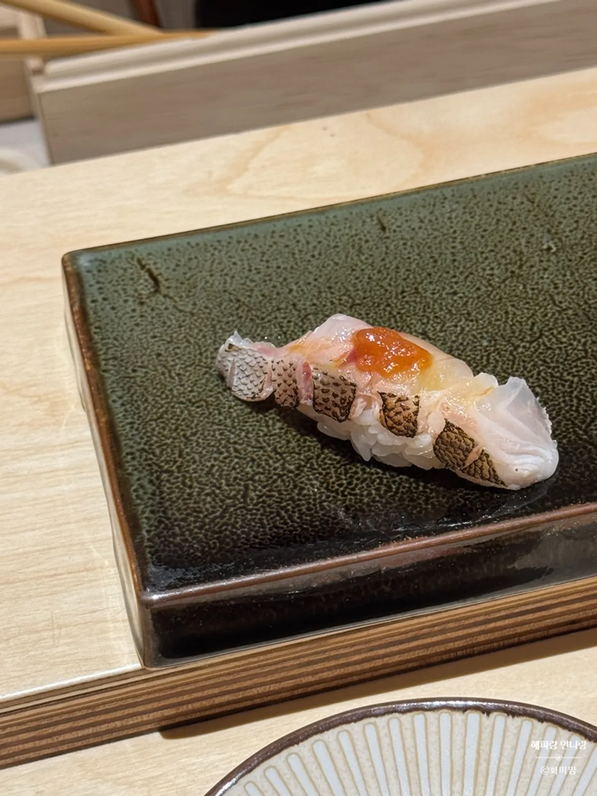 A piece of nigiri from Sushi Hibi's lunch omakase