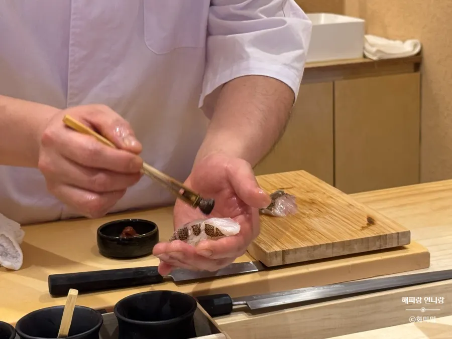 The chef prepping ingredients across the counter