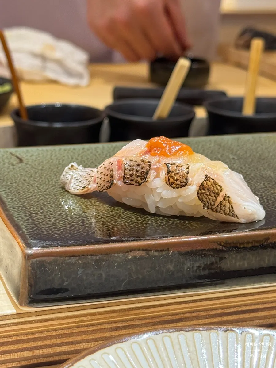 Amberjack nigiri topped with yuzu-kosho