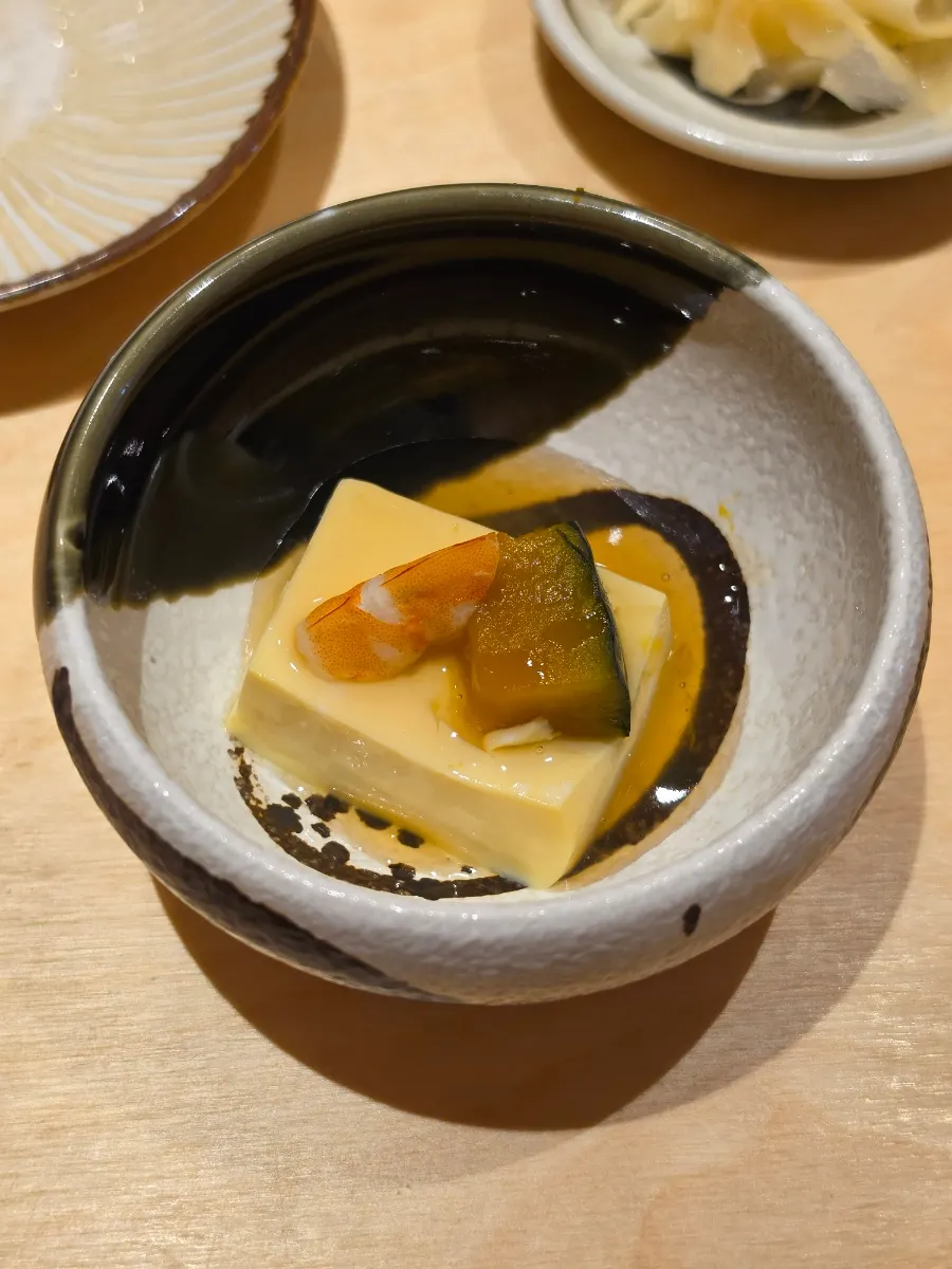 Egg tofu topped with shrimp and pumpkin