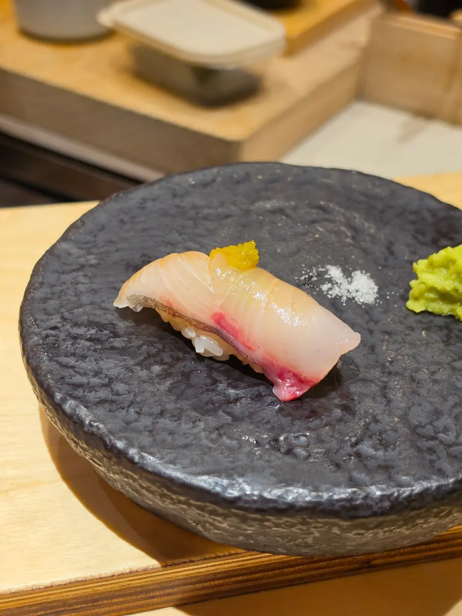 Greater amberjack nigiri topped with yuzu