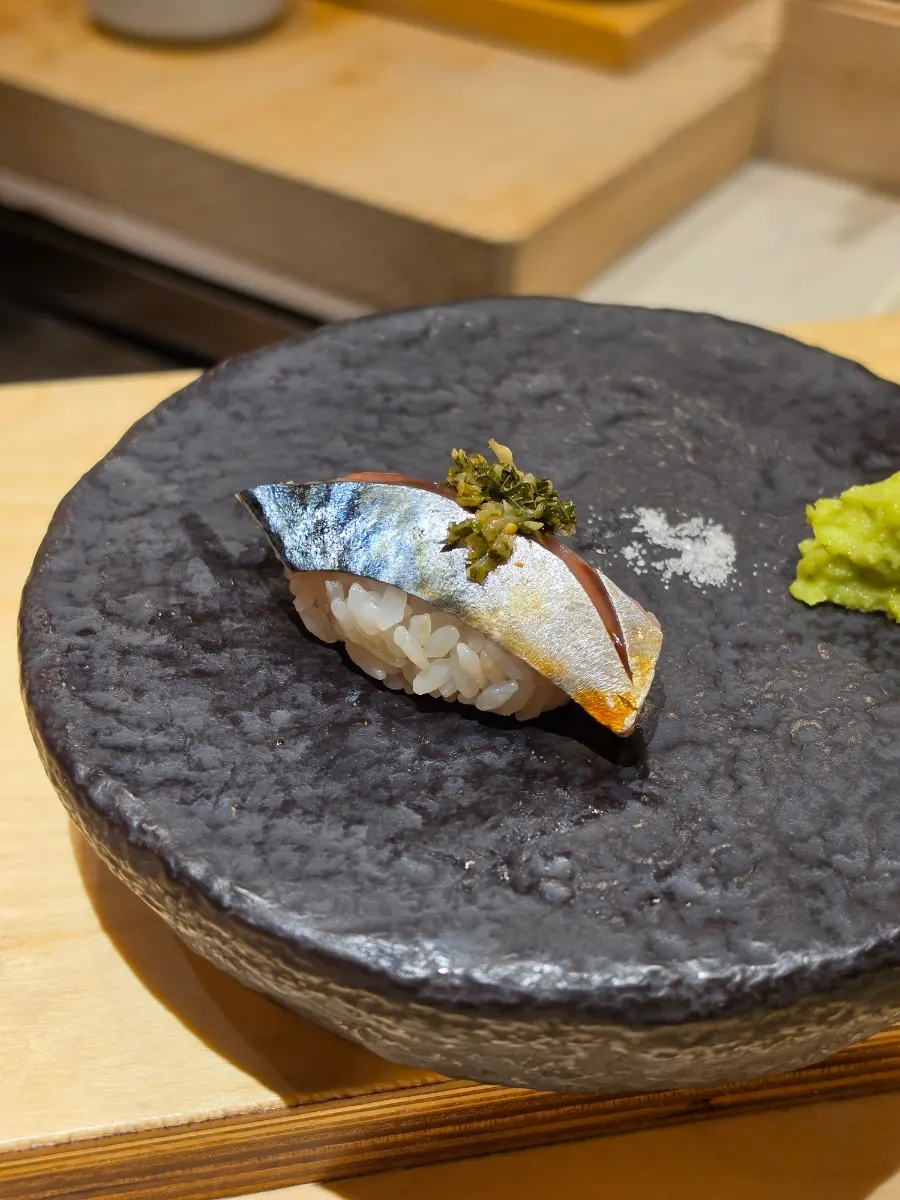 Mackerel nigiri topped with pickled ginger