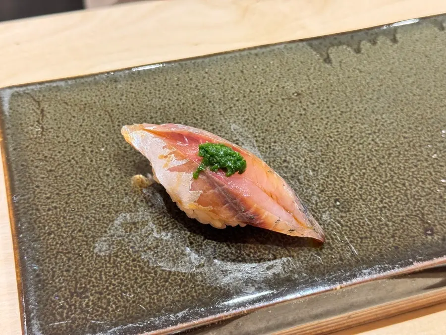 Horse mackerel nigiri topped with chopped scallion