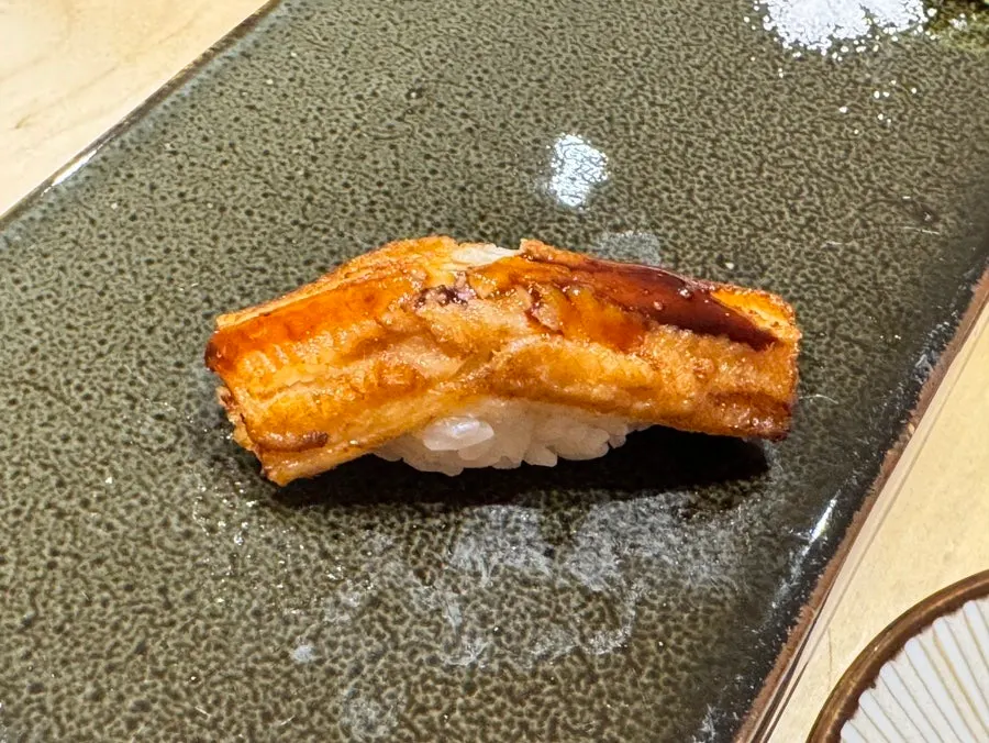 Warm saltwater eel unagi nigiri topped with sauce