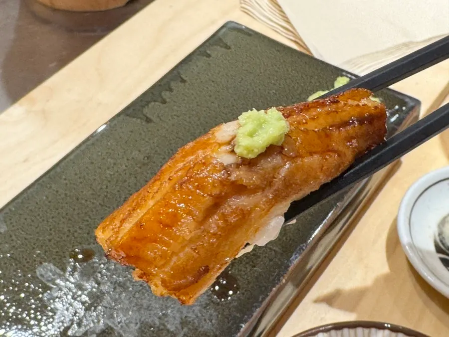 A piece of steaming unagi nigiri
