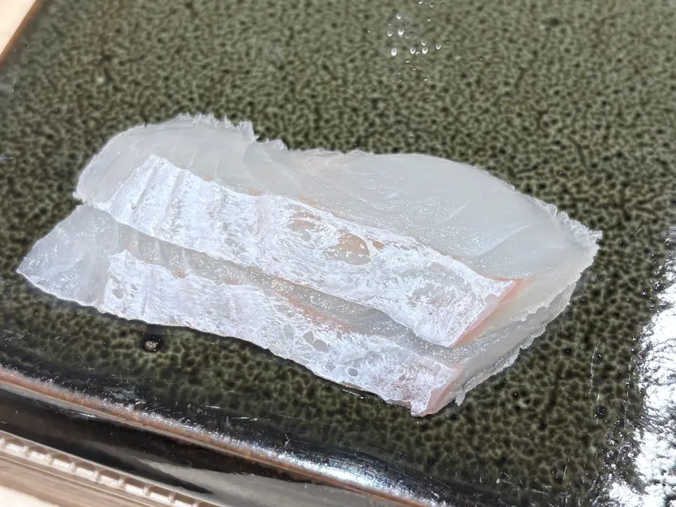 Two pieces of flounder sashimi
