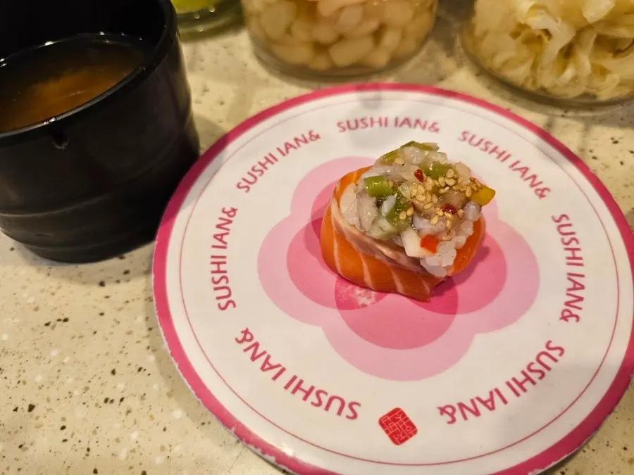 A plate of scallop garlic sushi