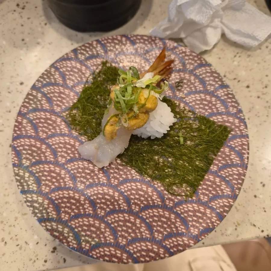 Close-up of sushi topped with sauce