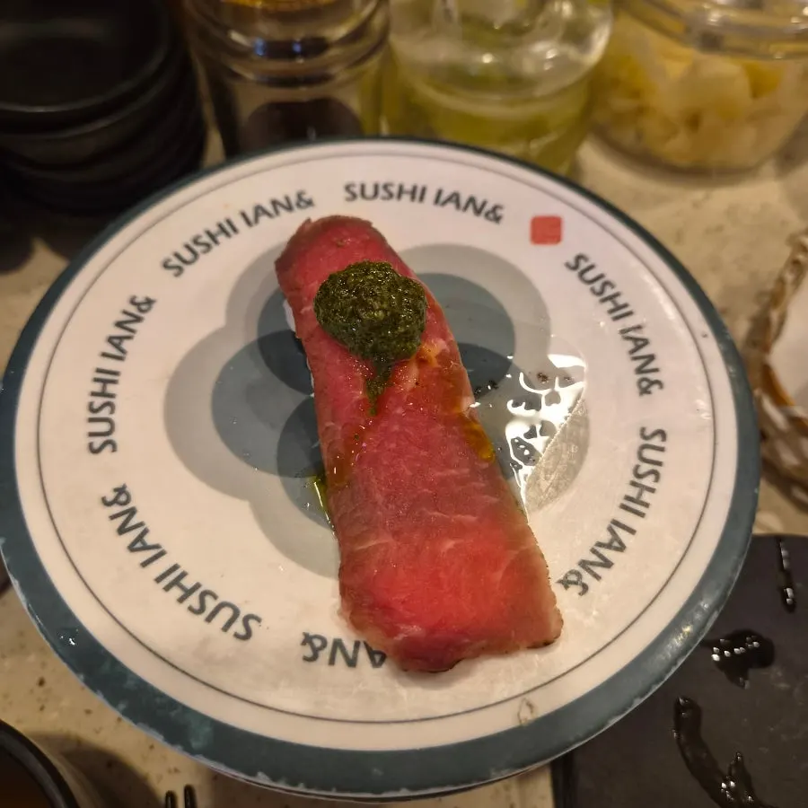 A plate of maki sushi including scallop maki