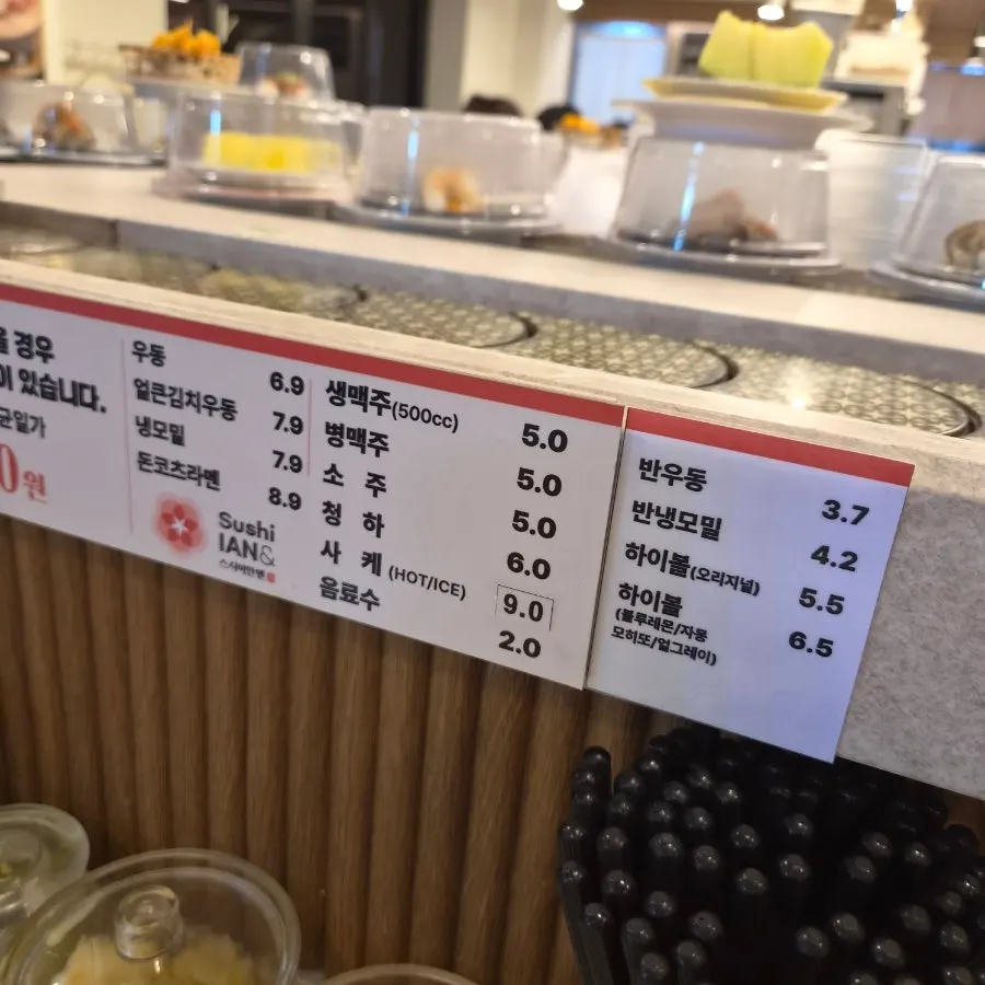 Side menu board listing half-size udon and cold soba