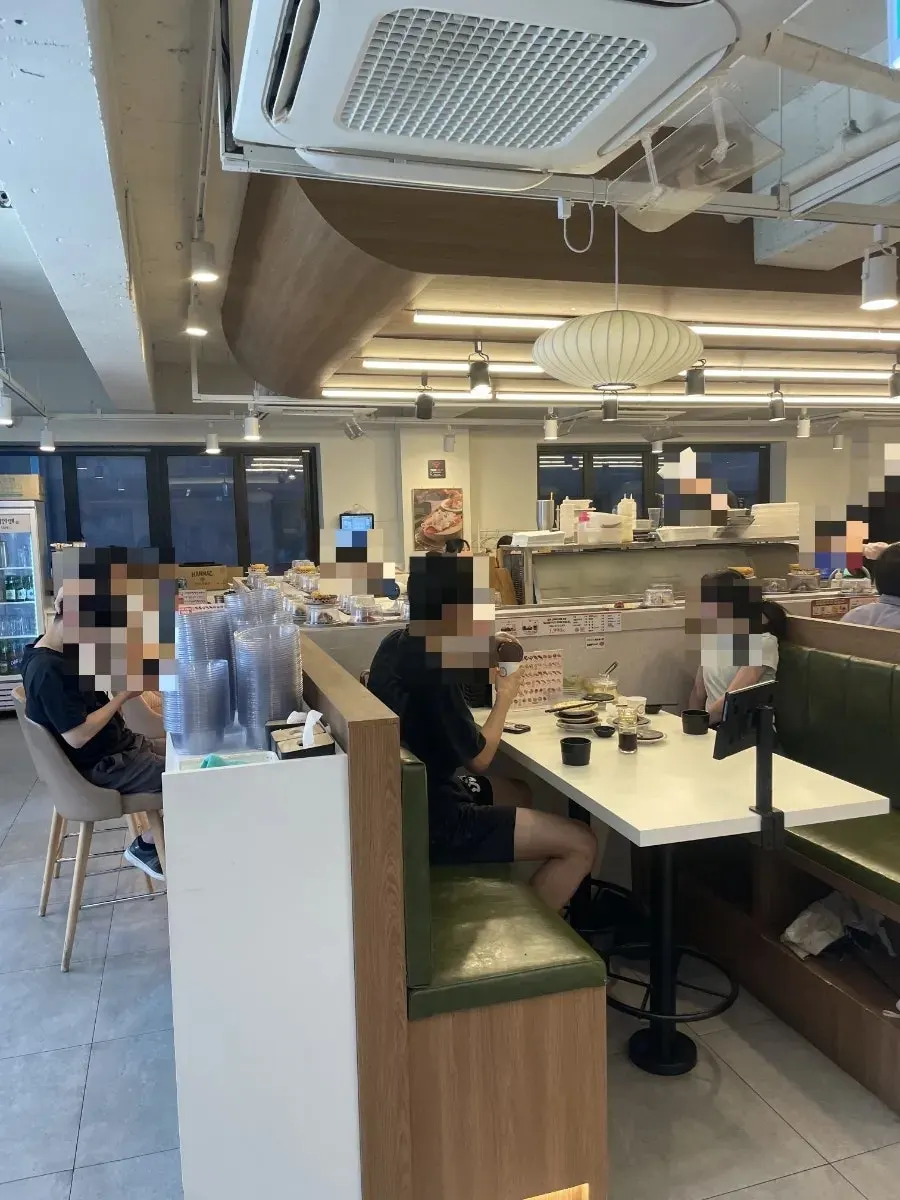 Interior of the conveyor-belt sushi restaurant with group table seating