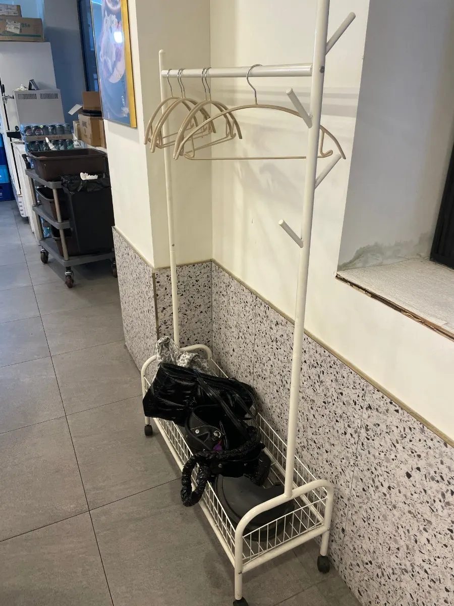 Apron and coat hanger set up beside the seating