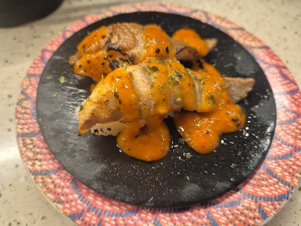 A plate of egg sushi with pork belly