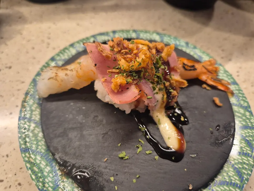A plate of bacon shrimp sushi
