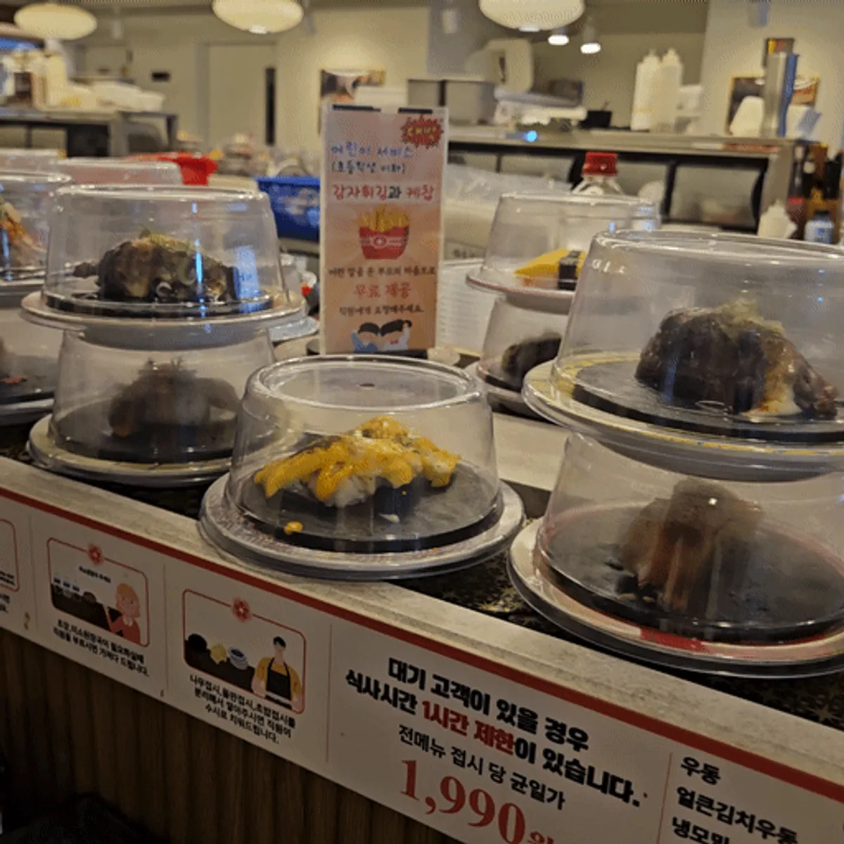 Sushi plates passing along the conveyor belt