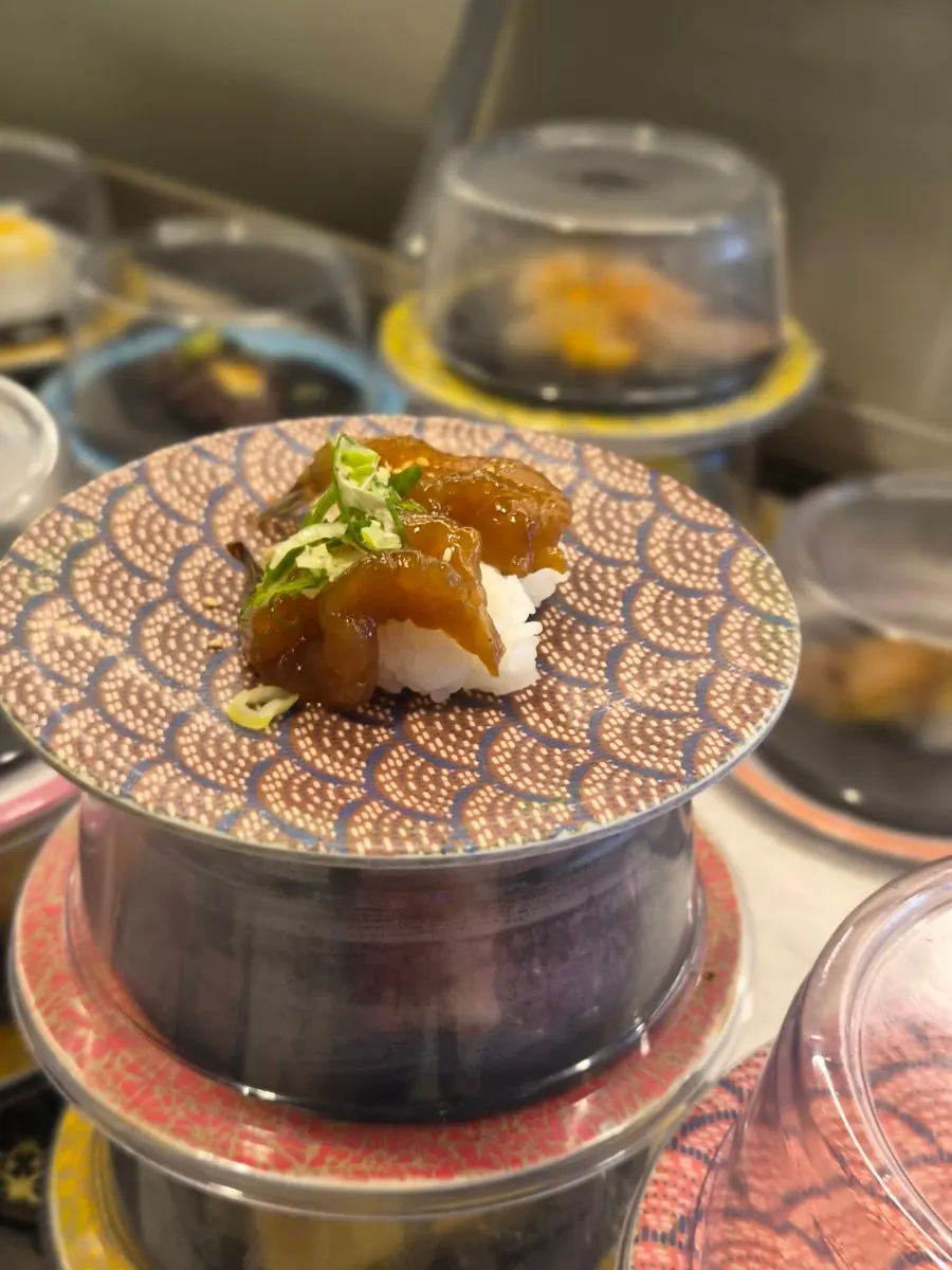 Sushi plates passing along the conveyor belt