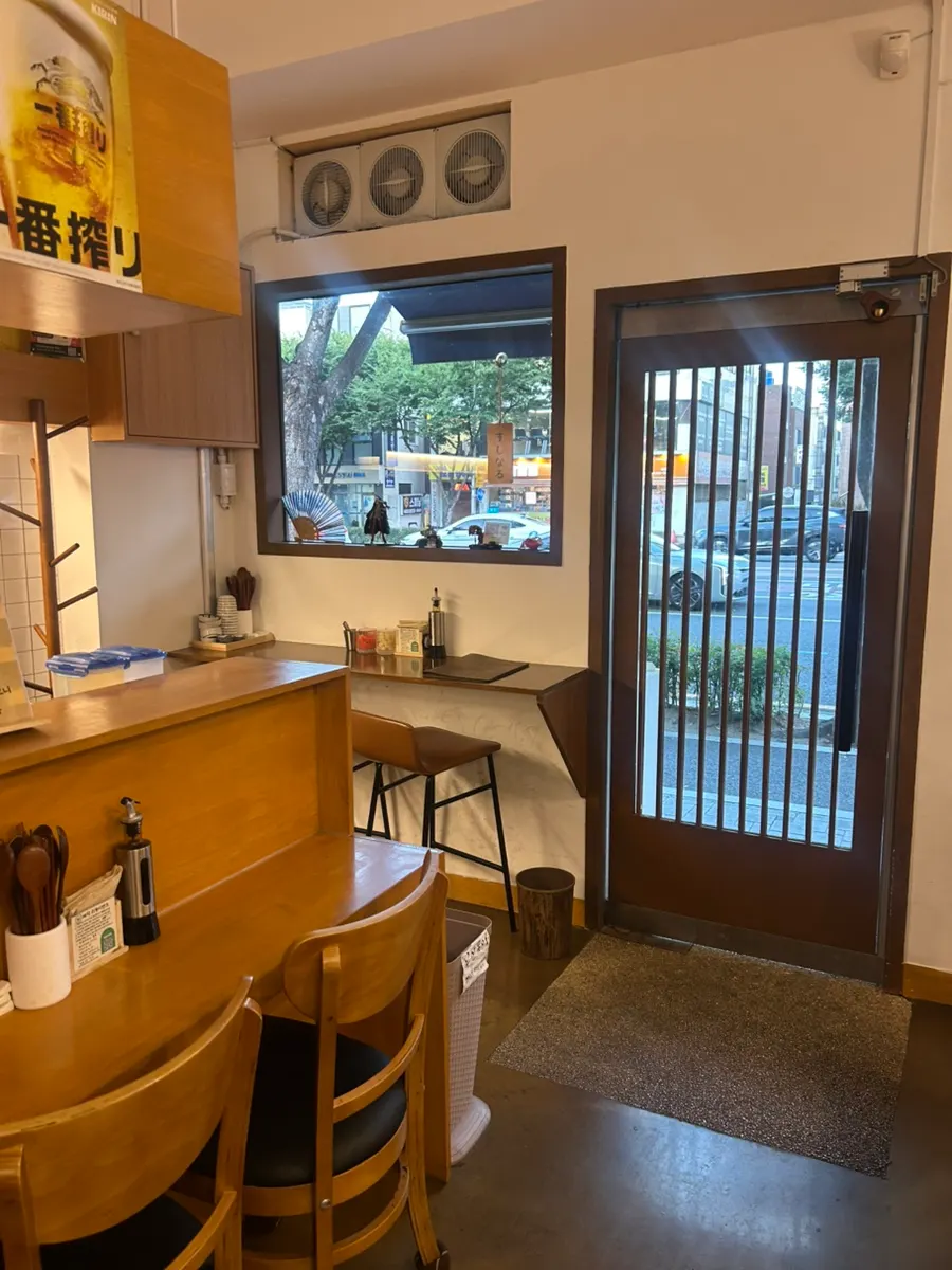 Interior of the shop with bar seats and tables