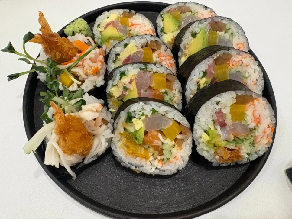 A beautifully plated dish of sushi and sides
