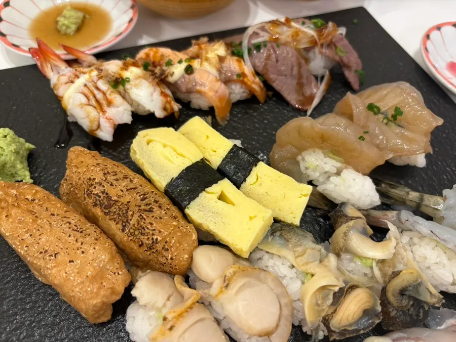 A plate of futomaki with fried shrimp and avocado