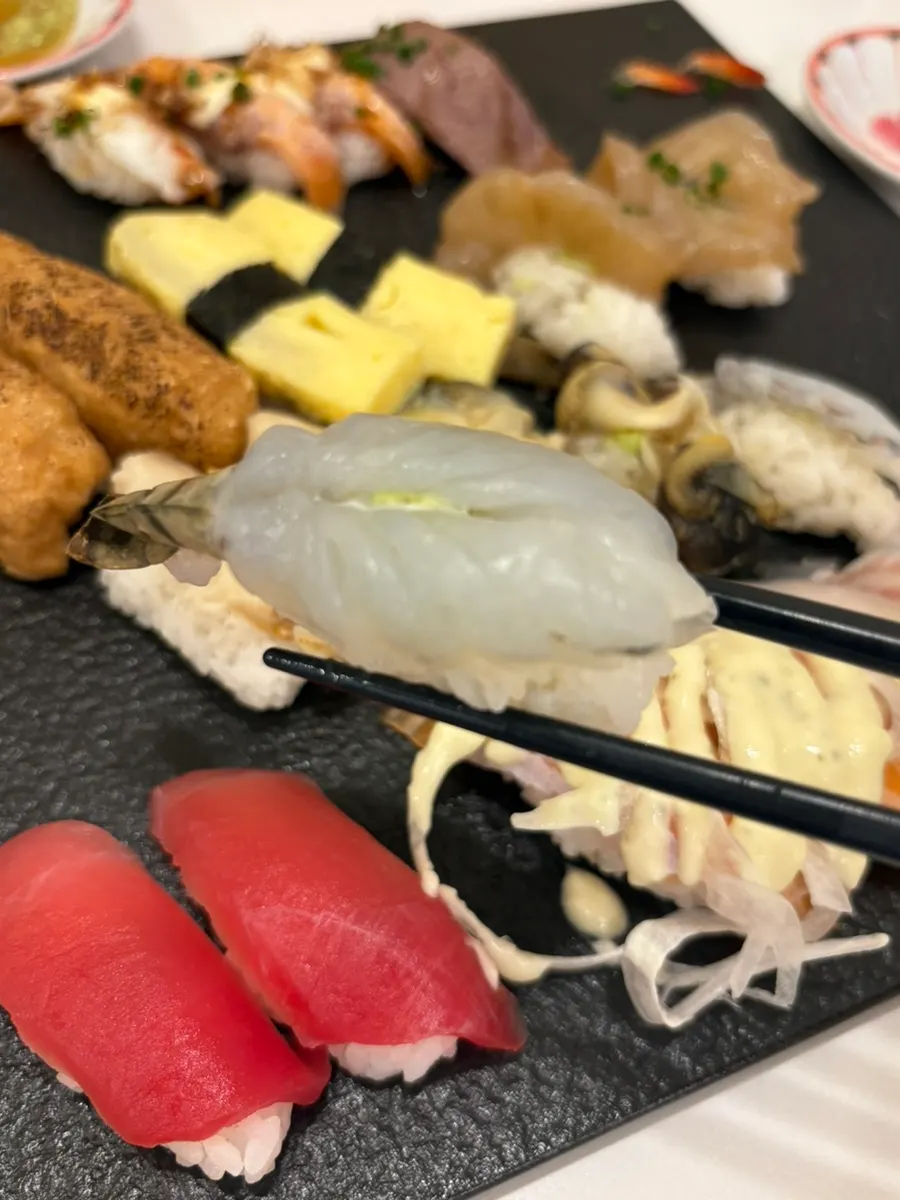 A piece of sushi picked up by hand